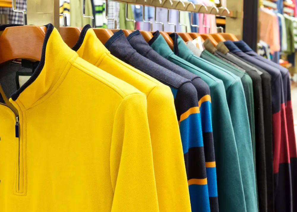 Colorful shirts hanging on a rack.