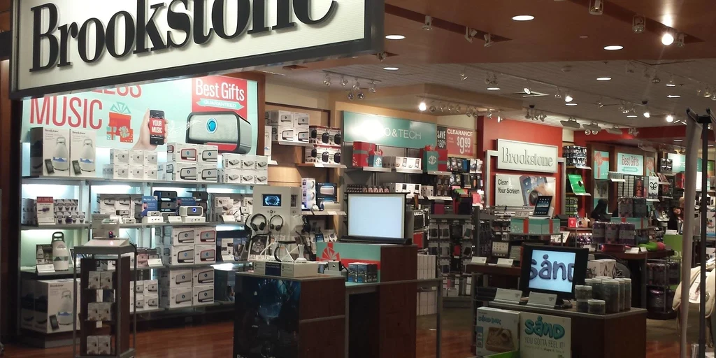 Electronics store with shelves of products.