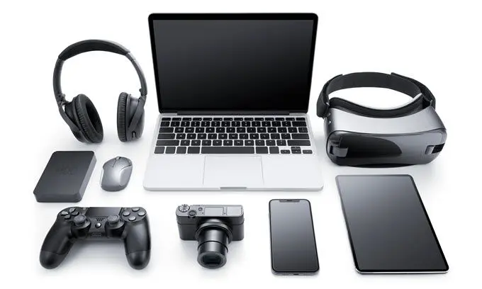 Laptop, headphones, VR headset, and other tech.