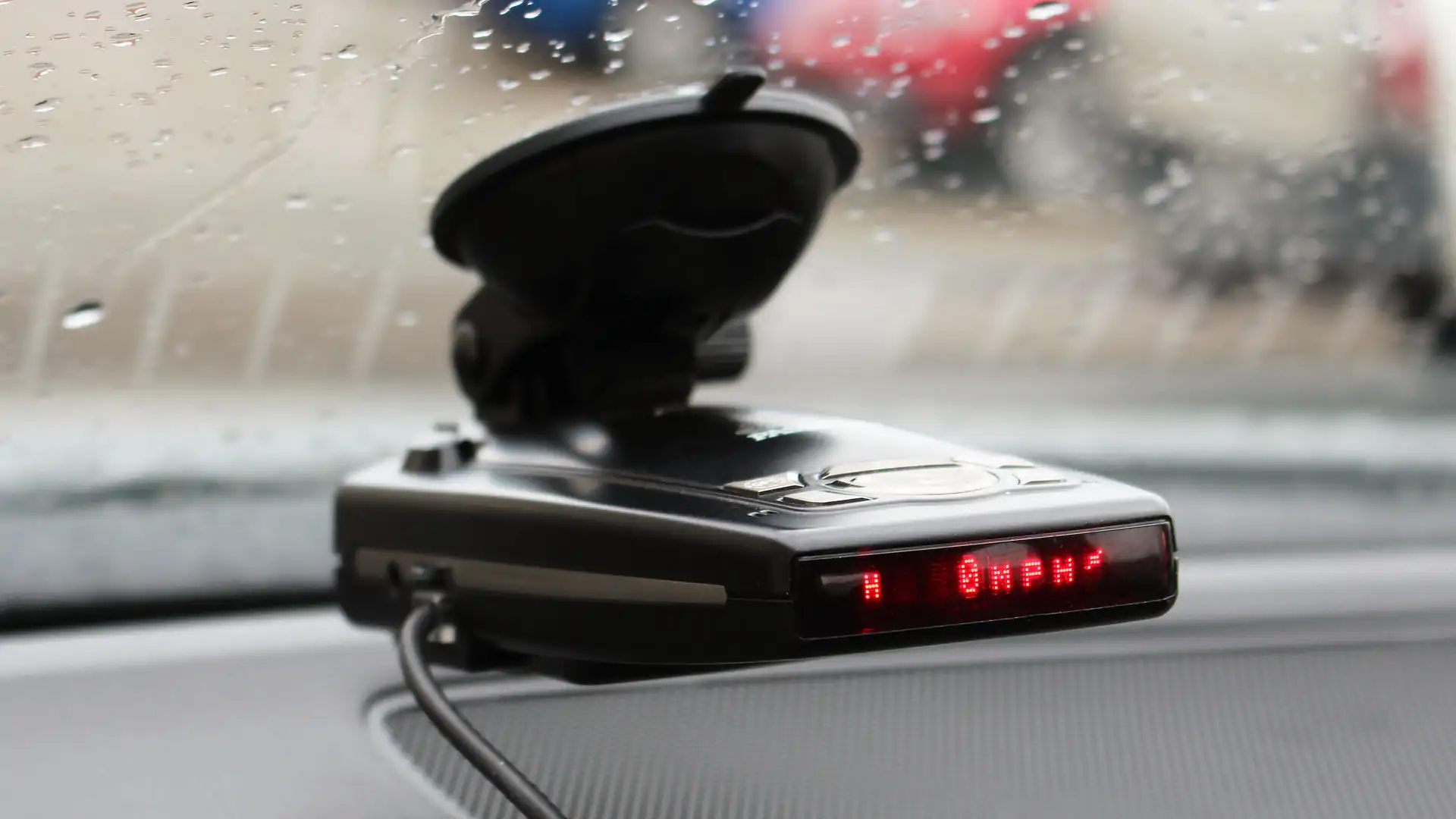 Black radar detector with red display.