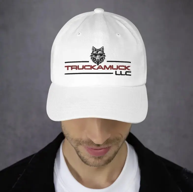 White baseball cap with Truckamuck LLC logo.