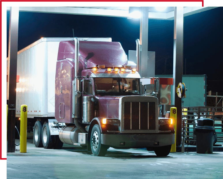 A truck is parked at the gas station.