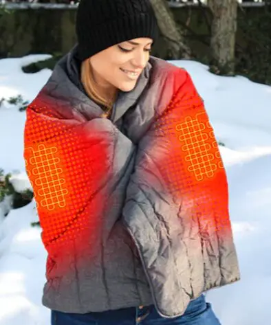 Woman in a heated jacket outdoors.