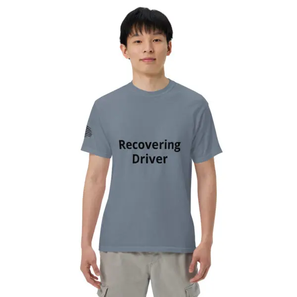 Man wearing a gray t-shirt that says "Recovering Driver"