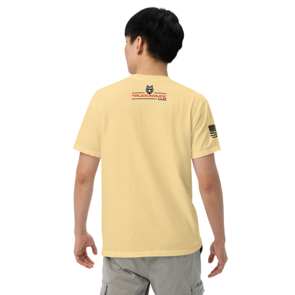 Man wearing a yellow t-shirt with a logo.