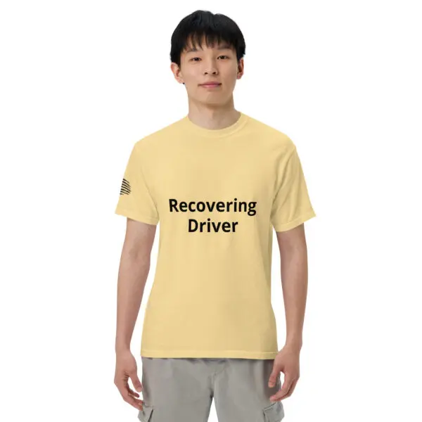 Man wearing a yellow "Recovering Driver" t-shirt.