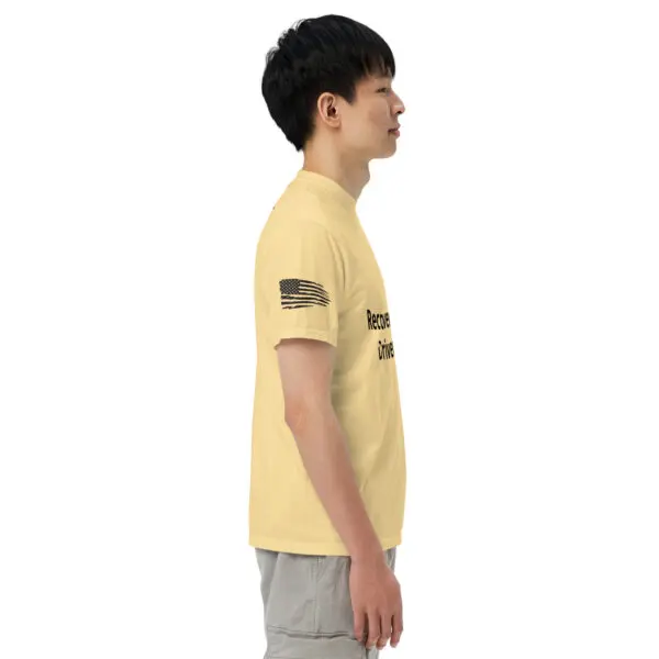 Man wearing yellow t-shirt with US flag and text.