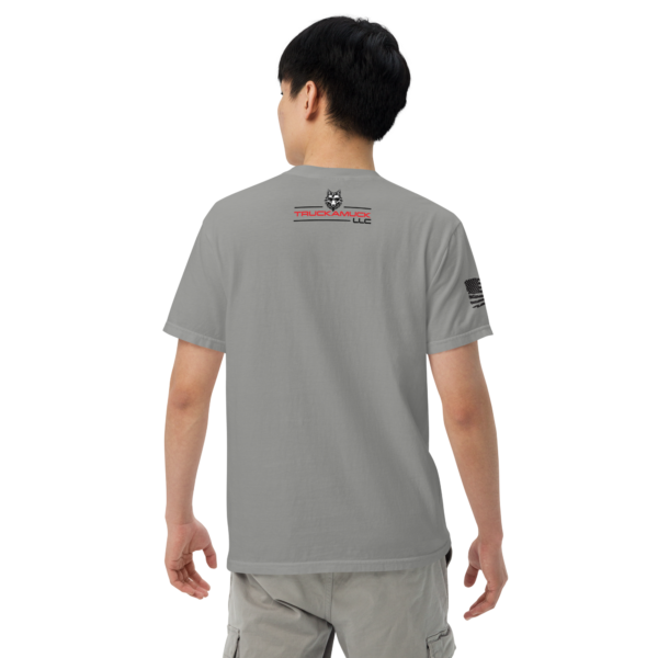 Man wearing a gray T-shirt with a logo.