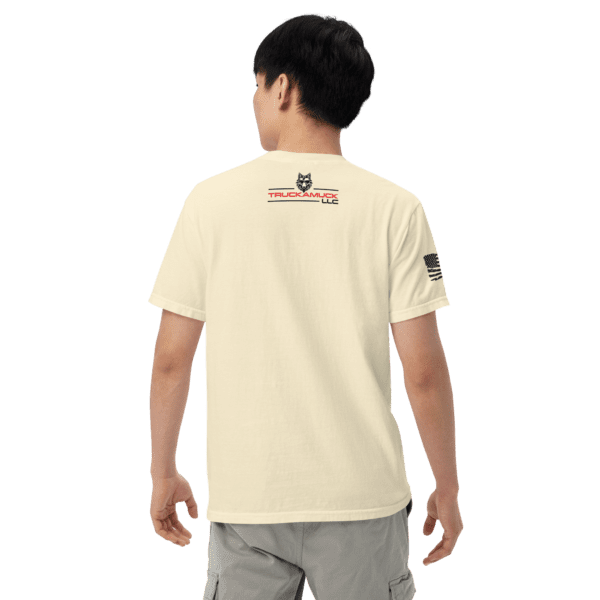 Man wearing a cream t-shirt with a logo.