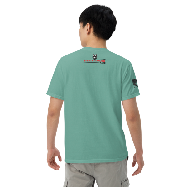 Man wearing a teal t-shirt with logo.