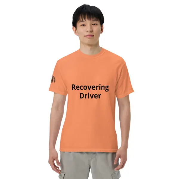 Man wearing a peach "recovering driver" t-shirt.