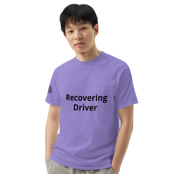 Man in purple shirt with "Recovering Driver" text.