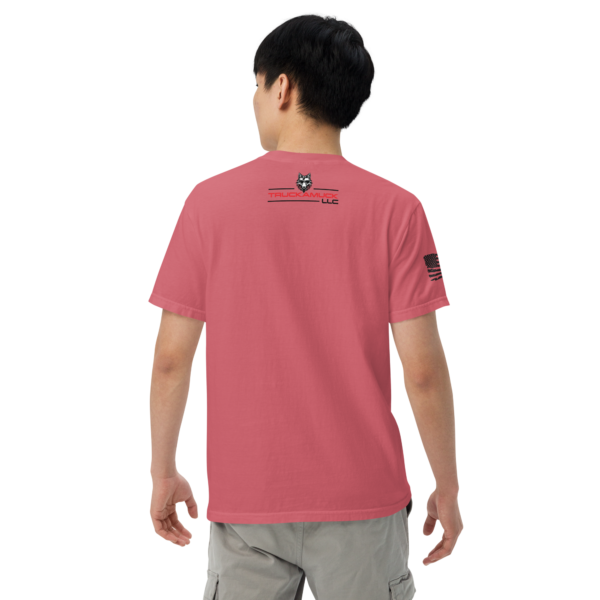 Man wearing a pink t-shirt with a logo.