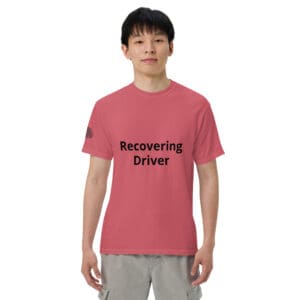 Man wearing a pink "Recovering Driver" t-shirt.