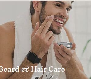 Man applying beard cream, smiling.