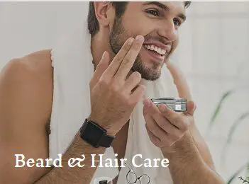 Man applying beard cream, smiling.