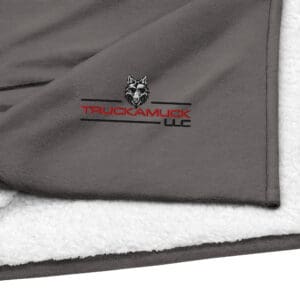 Gray fleece blanket with Truckamuck logo.