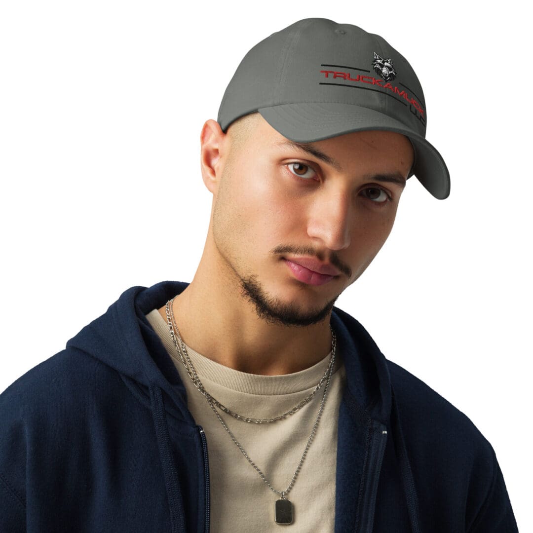 Man wearing a gray Trucker cap.