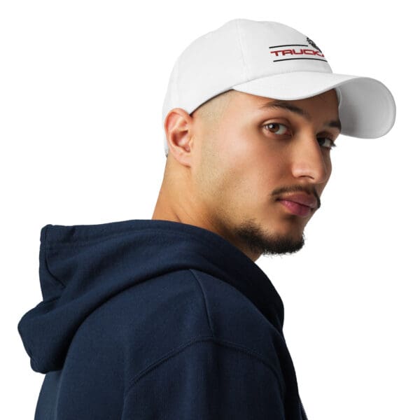 Man wearing a white "Truck" baseball cap.