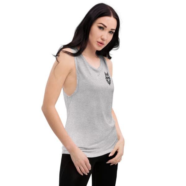 Woman in gray tank top with wolf design.