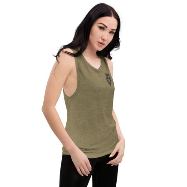 Woman wearing a green tank top with a wolf design.