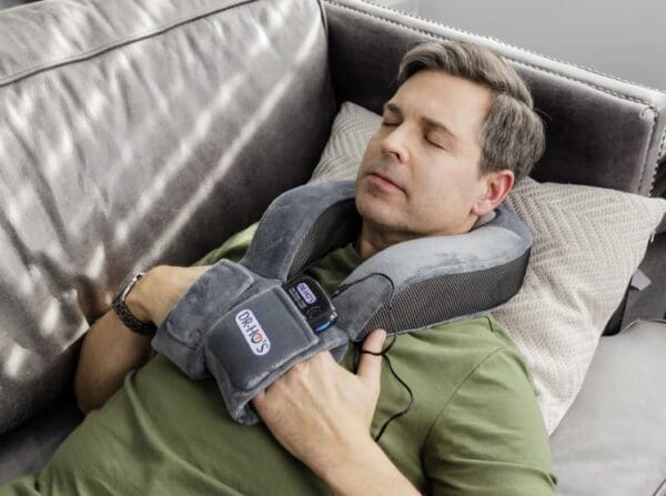 Man relaxing with a neck massager.